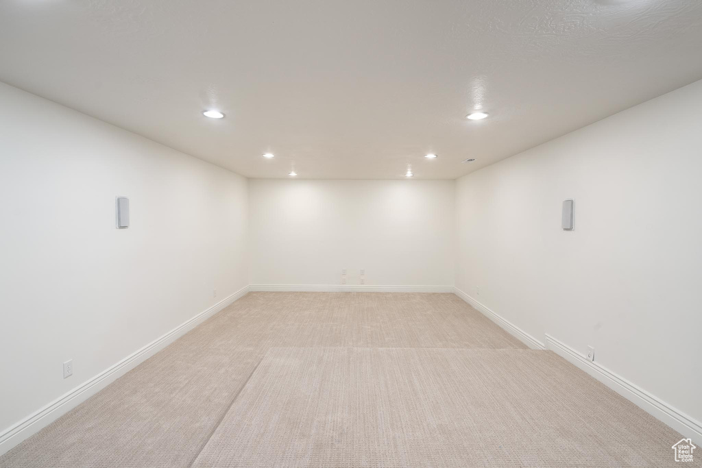 Finished basement with recessed lighting, light colored carpet, and baseboards