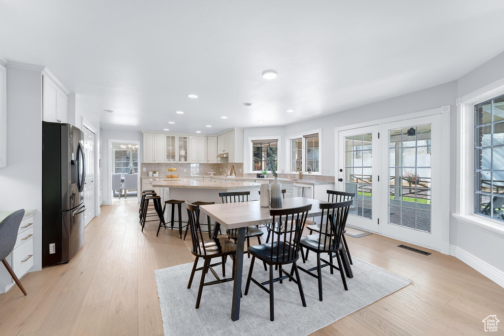 Dining area featuring light wood finished floors, recessed lighting, and baseboards