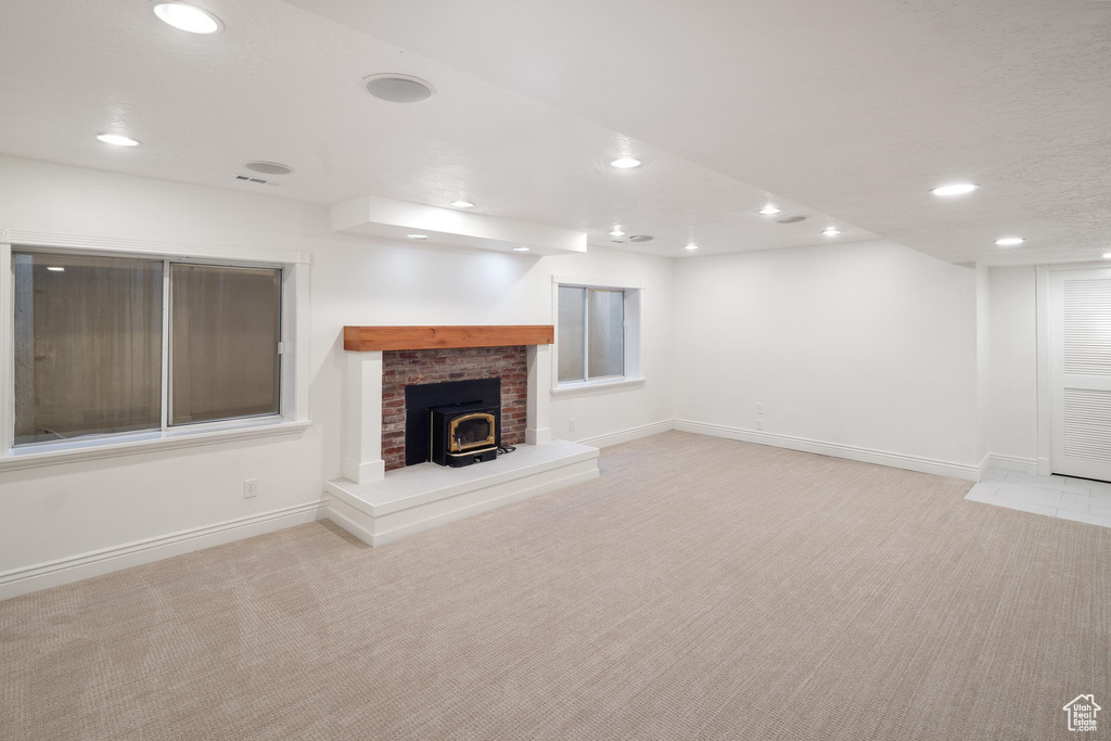 Unfurnished living room featuring carpet floors, recessed lighting, and baseboards