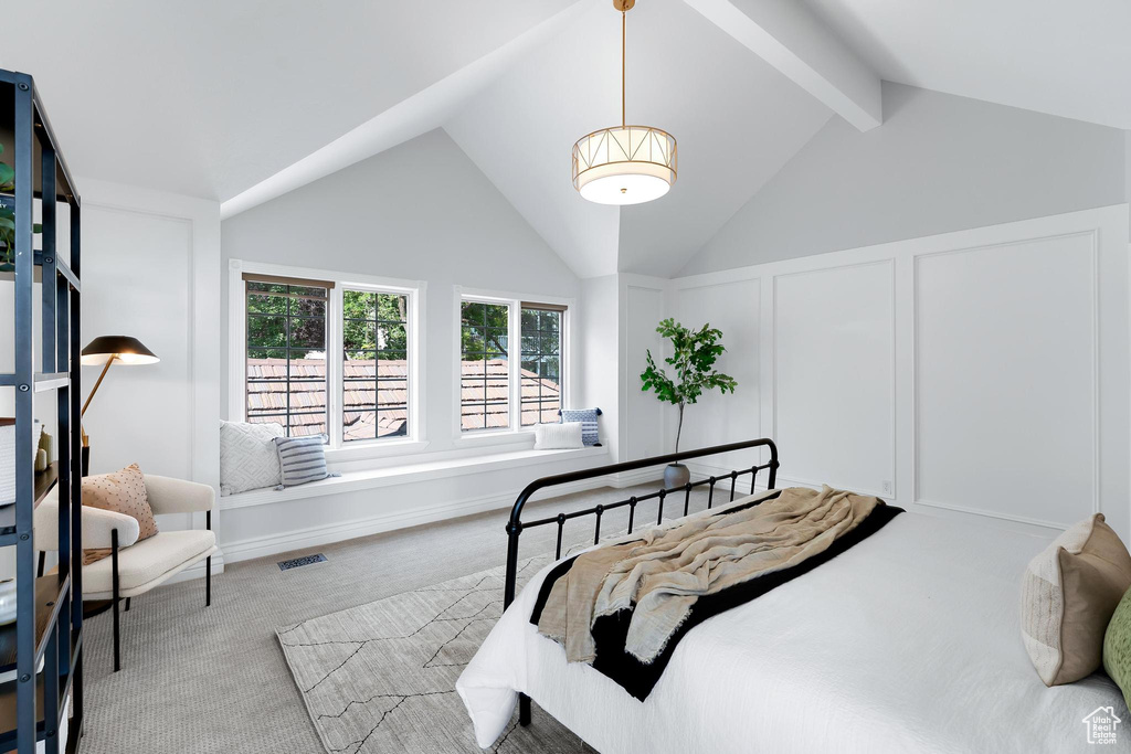Bedroom featuring carpet flooring and a decorative wall