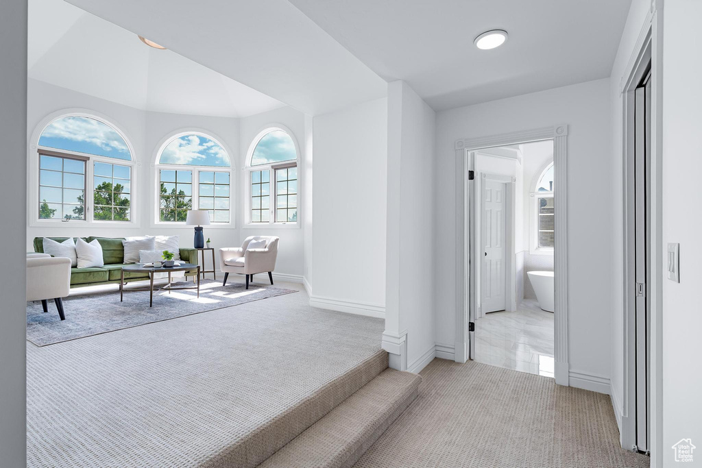 Hall featuring carpet floors and baseboards