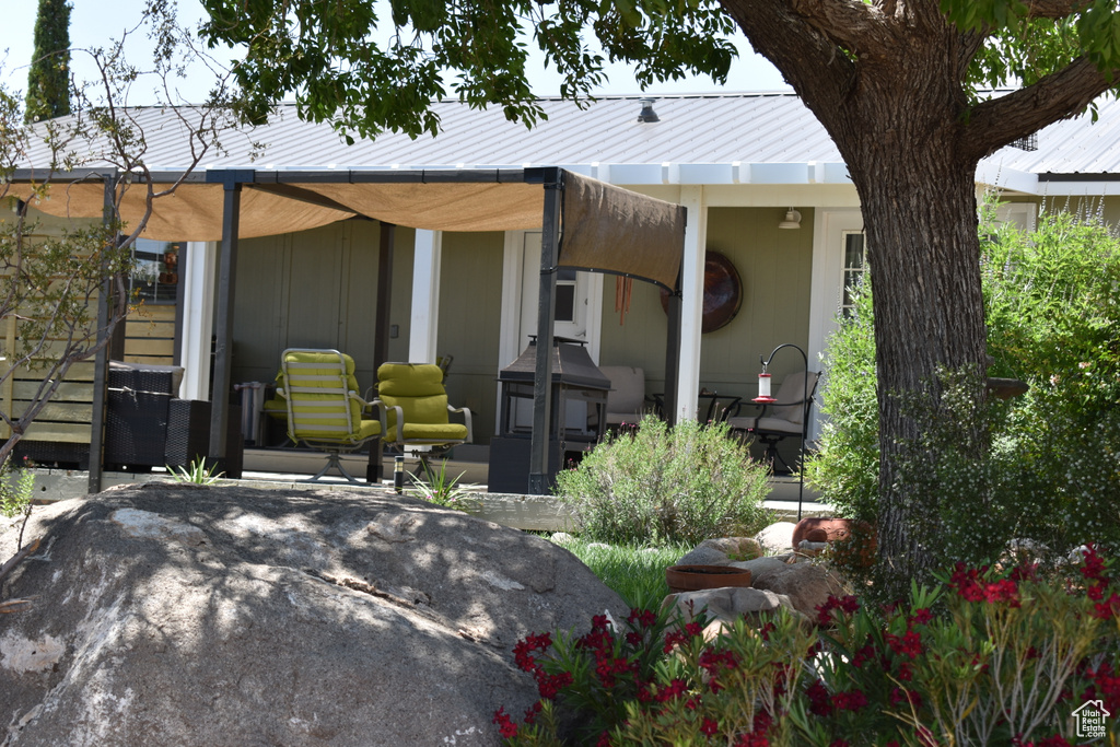 Back of house featuring a patio area and metal roof