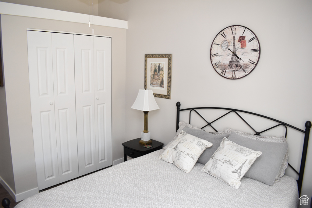 Bedroom with a closet, baseboards, and carpet