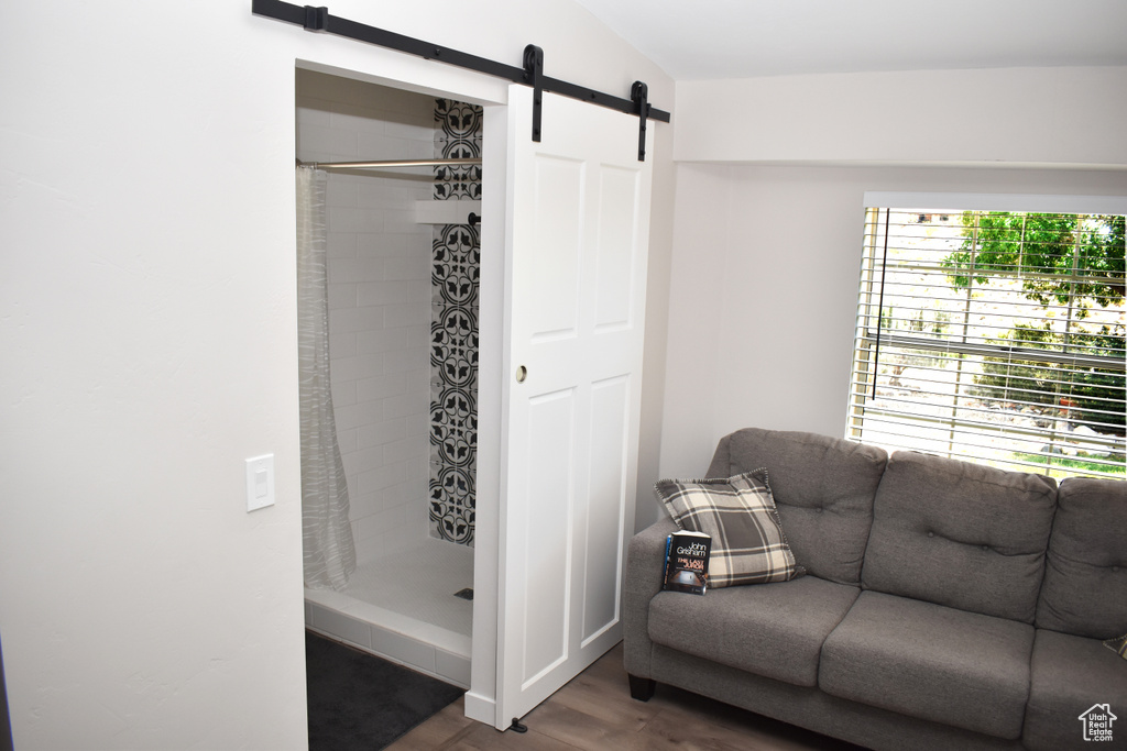 Interior space with a barn door and wood finished floors