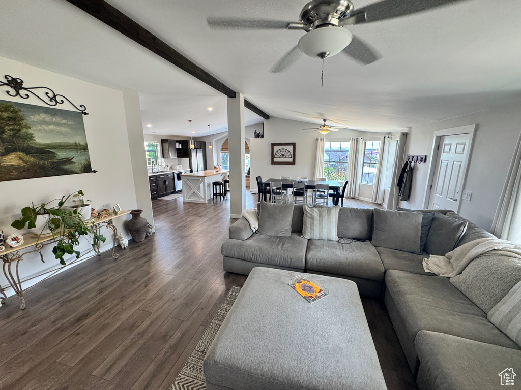 Living area with a ceiling fan, dark wood-type flooring, and recessed lighting