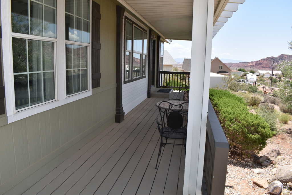 Wooden porch featuring a mountain view