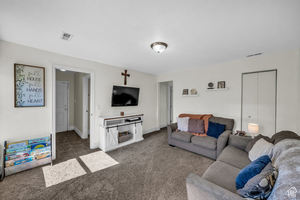 Carpeted living room featuring baseboards
