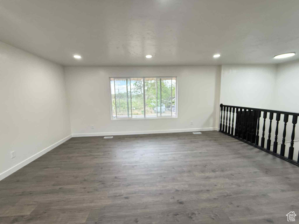 Spare room with baseboards, recessed lighting, and wood finished floors