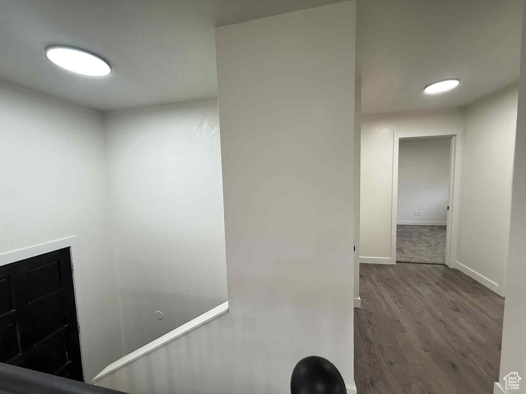Corridor featuring wood finished floors and baseboards