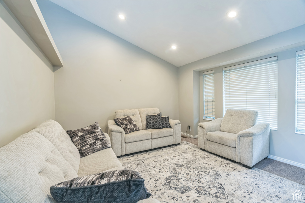 Living room featuring baseboards, carpet flooring, recessed lighting, and vaulted ceiling