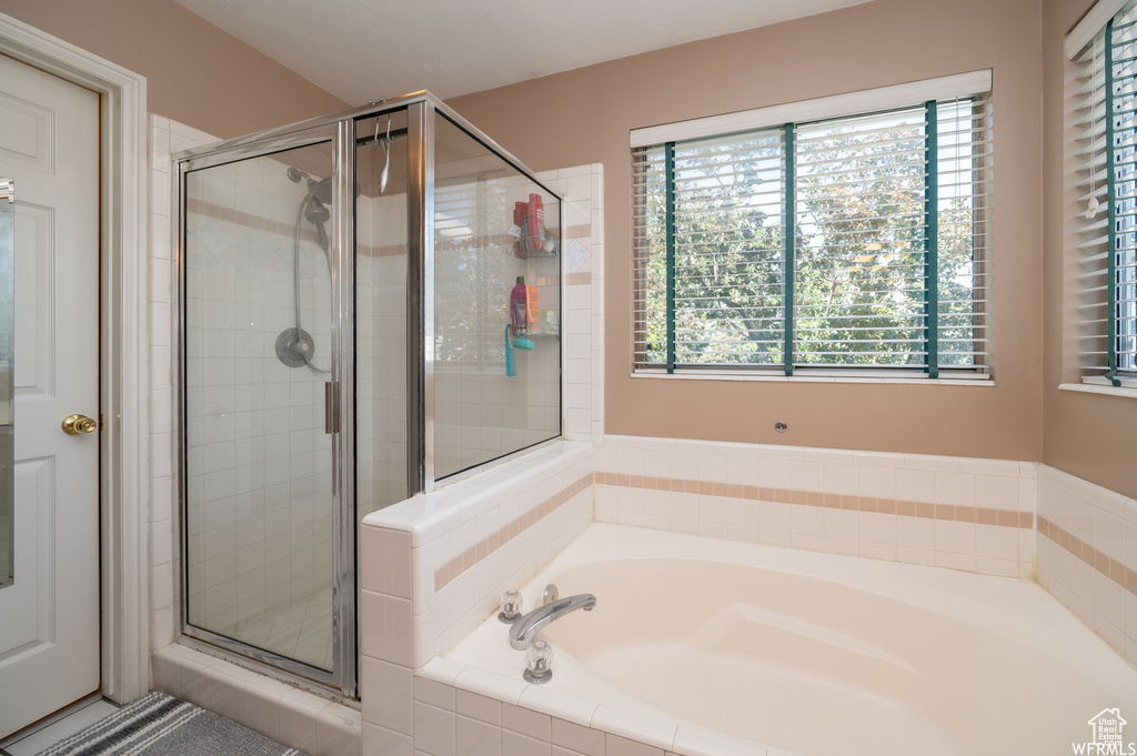 Bathroom featuring a stall shower and a garden tub