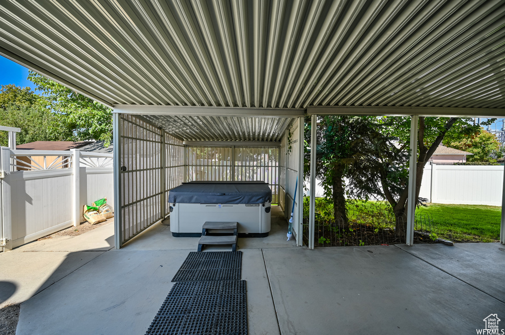 View of parking / parking lot with a fenced backyard