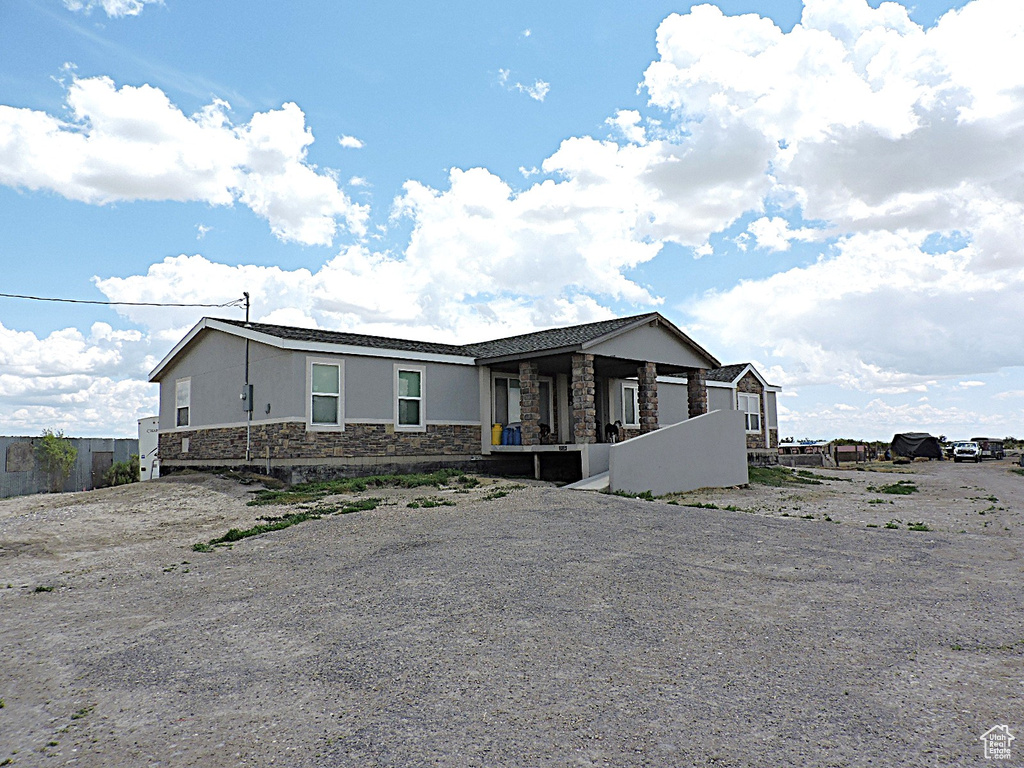 View of front of house with stone siding and stucco siding