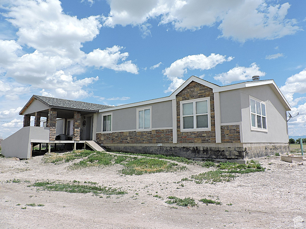 View of front of home with stone siding and stucco siding