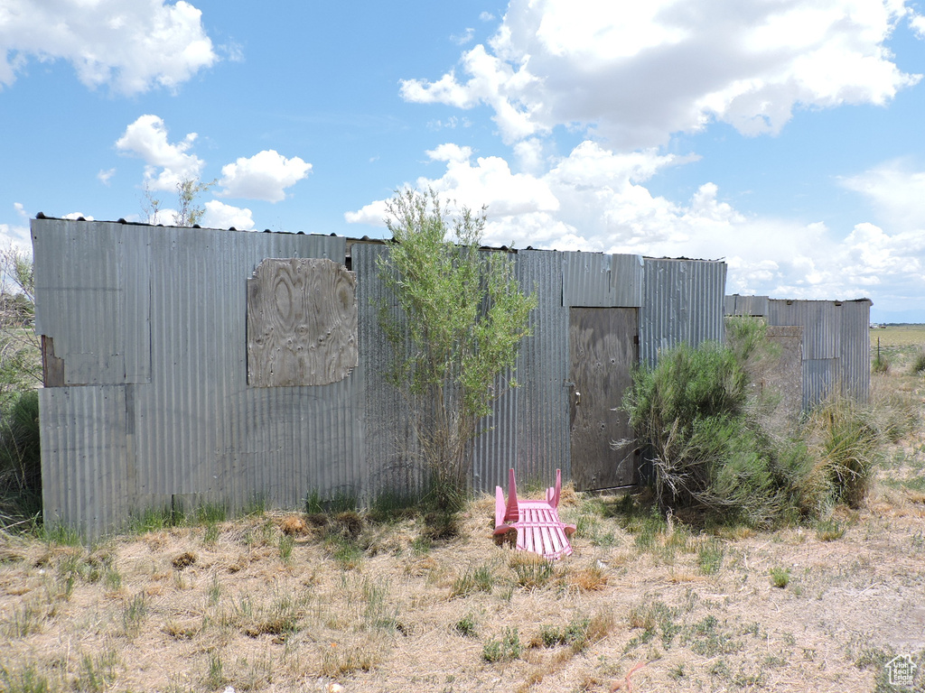 View of property exterior with an outbuilding and an outdoor structure
