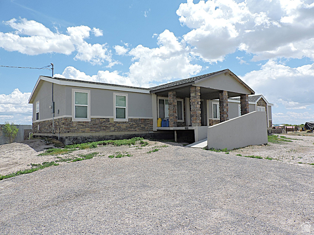 View of front of property with stone siding and stucco siding