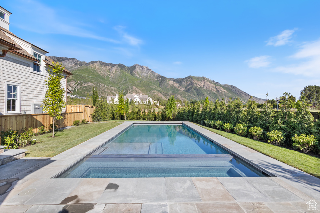View of swimming pool with a mountain view and an in-ground hot tub