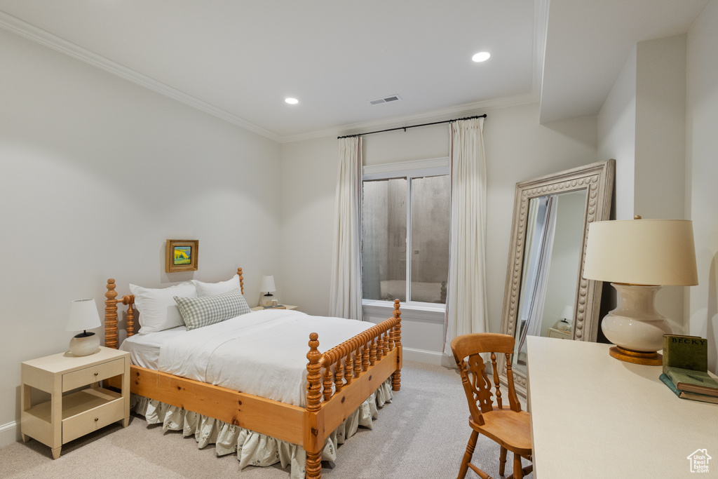 Bedroom with light colored carpet, ornamental molding, baseboards, and recessed lighting
