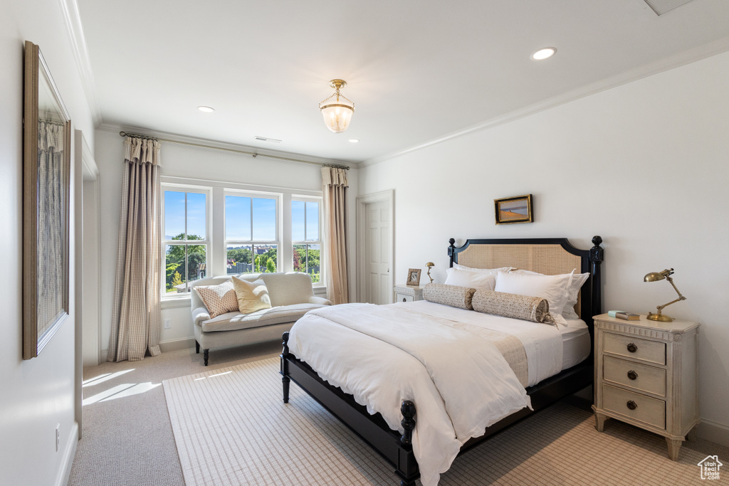 Bedroom with light colored carpet, baseboards, recessed lighting, and crown molding