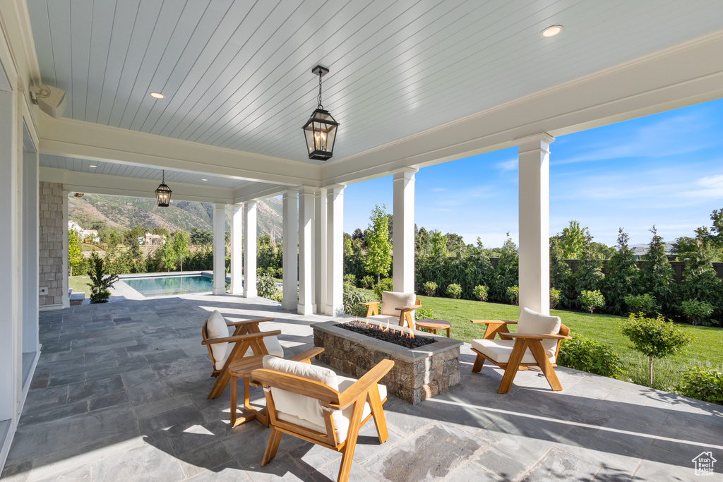 View of patio / terrace featuring a fire pit and an outdoor pool