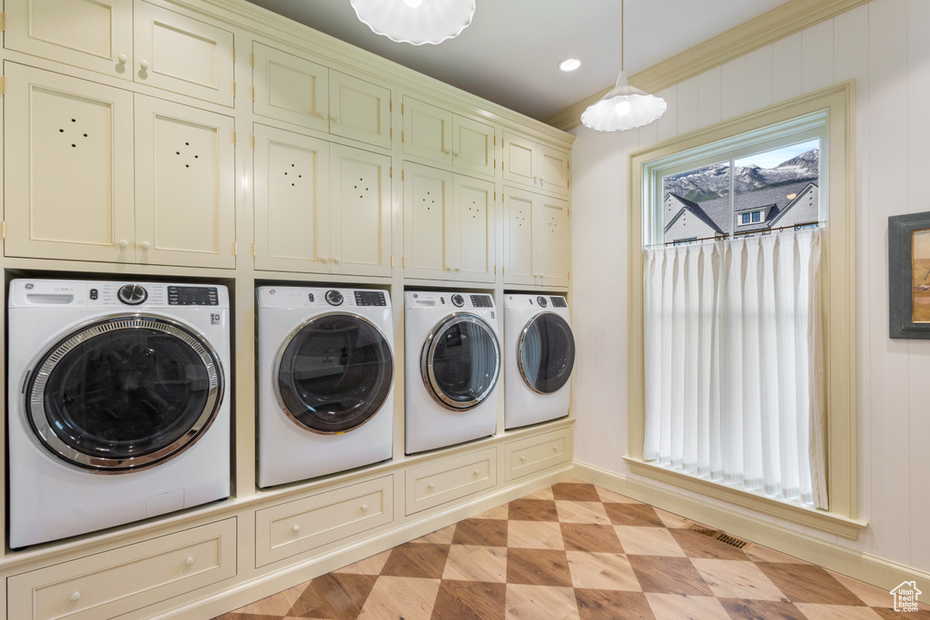 Laundry area featuring washing machine and dryer, cabinet space, baseboards, and recessed lighting