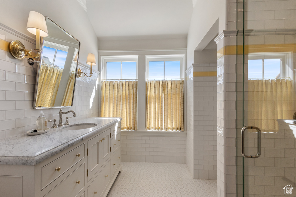 Full bath featuring vanity and a shower stall