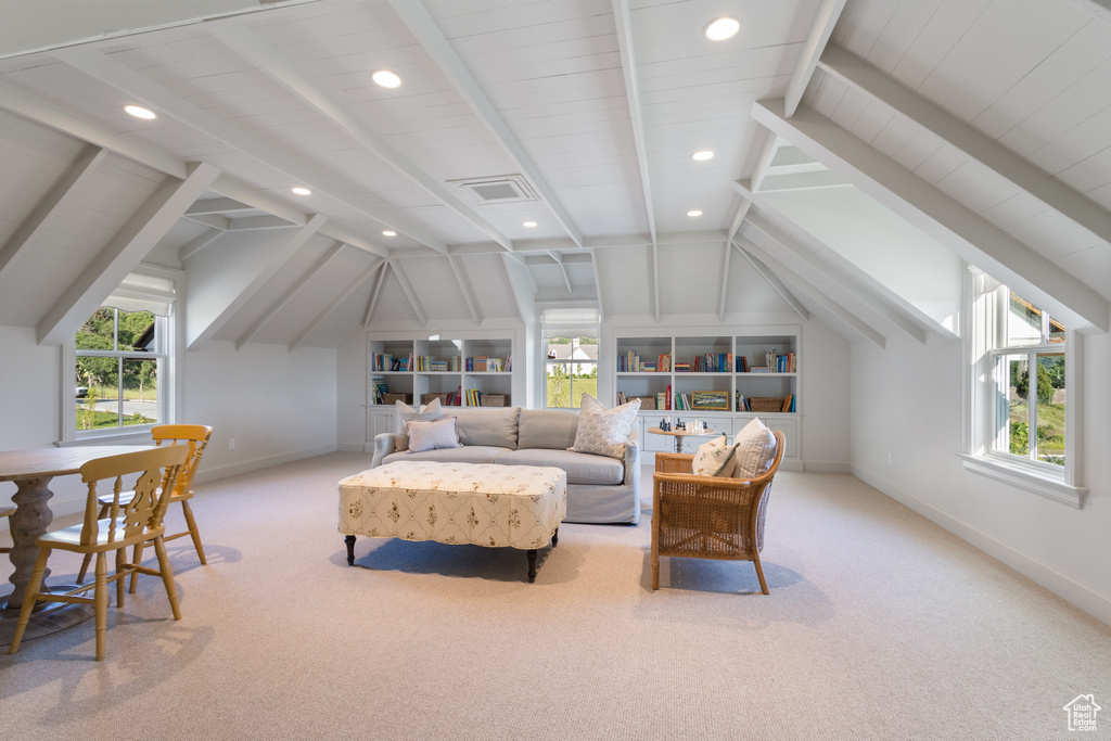 Living area featuring carpet flooring, baseboards, recessed lighting, and built in shelves