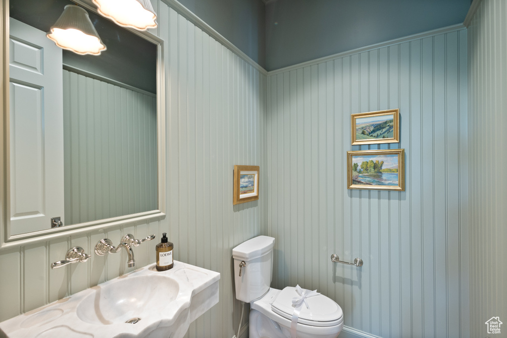 Half bathroom with a sink and toilet