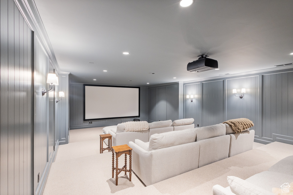 Home theater room with a decorative wall, recessed lighting, and carpet floors