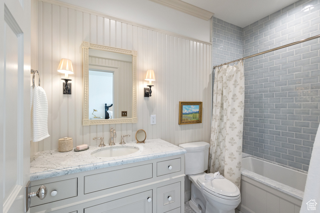 Full bathroom with vanity, toilet, and shower / bathtub combination with curtain