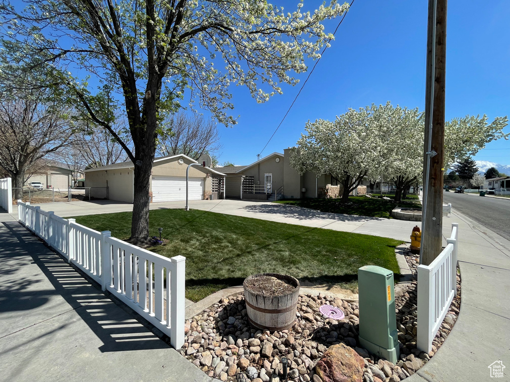 View of front facade featuring driveway and a garage