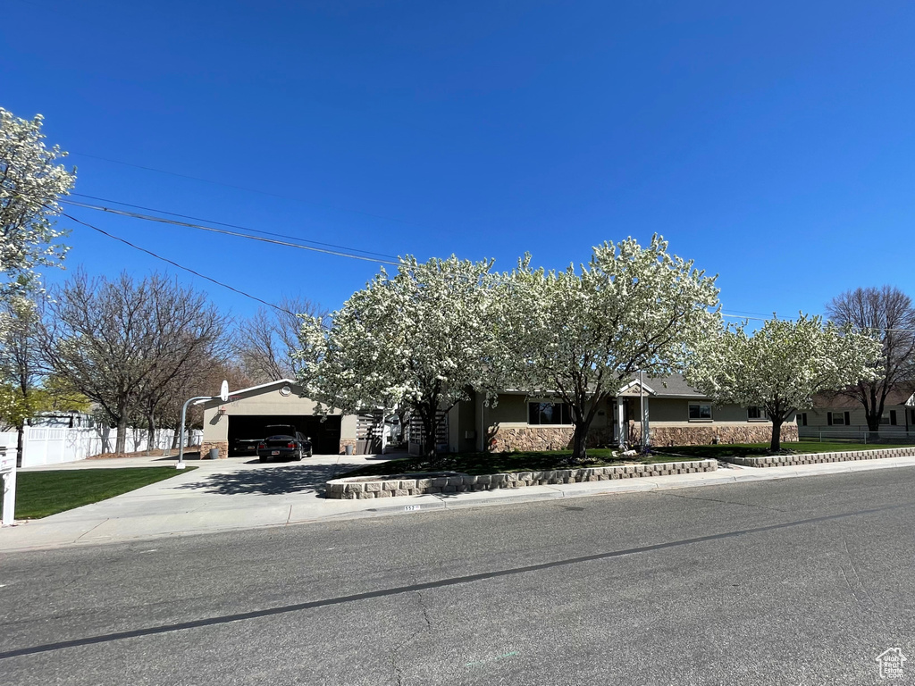 Obstructed view of property with an attached garage and driveway