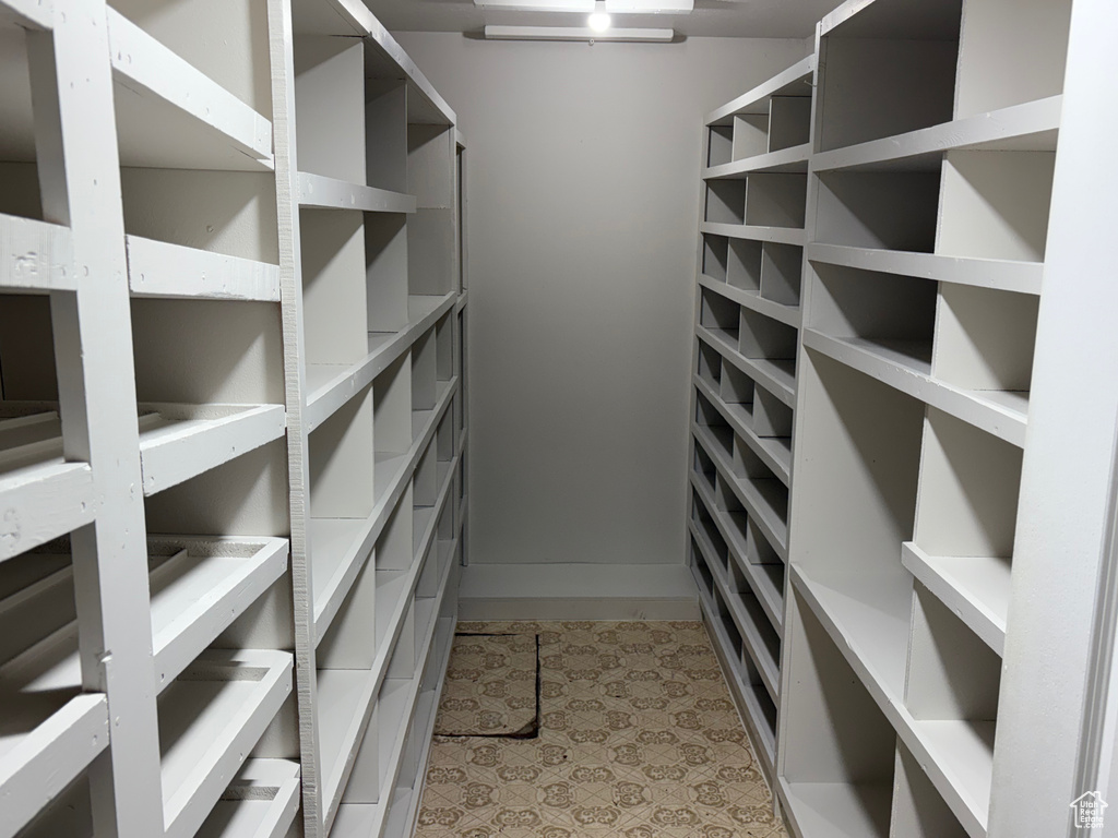 Spacious closet with light tile patterned floors