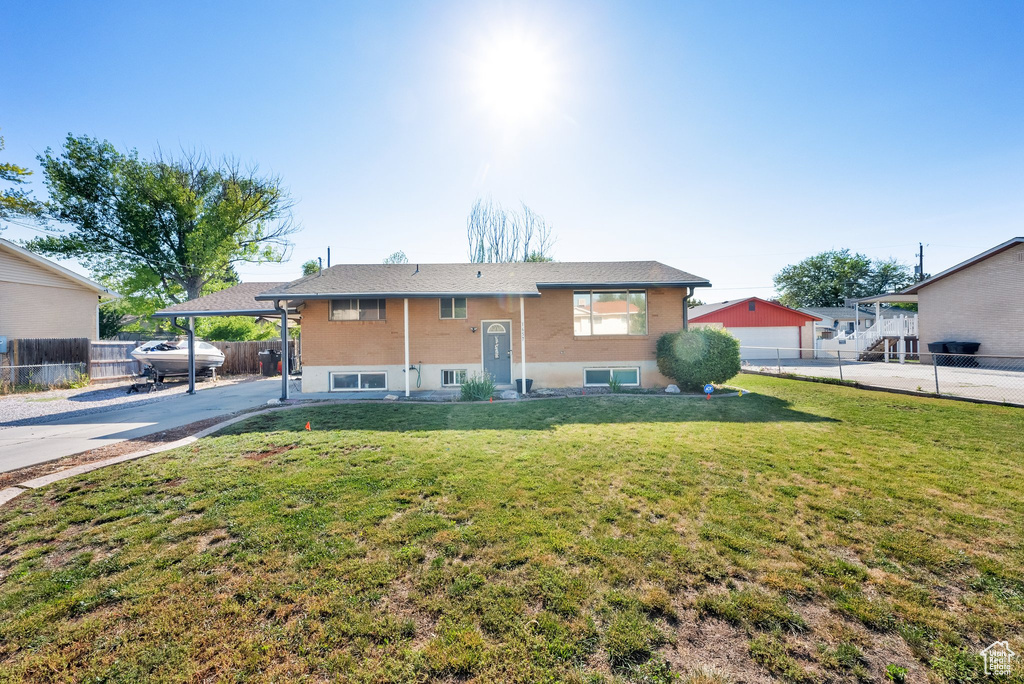 Raised ranch featuring driveway and a carport