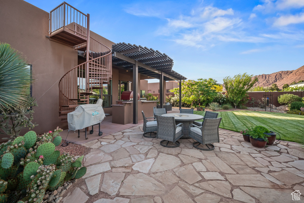 View of patio / terrace with stairway, a pergola, a mountain view, outdoor dining space, and a balcony