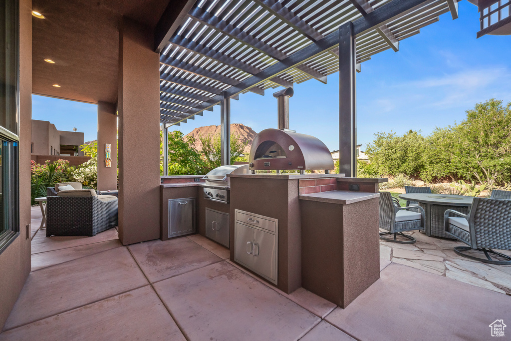 View of patio featuring a pergola and outdoor dining area