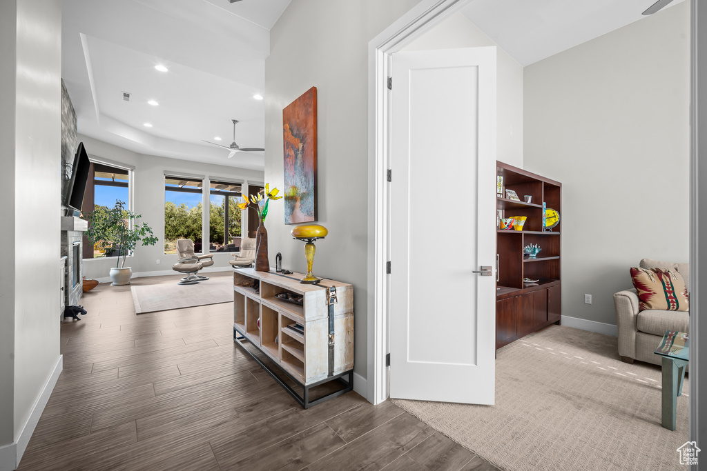 Corridor featuring baseboards, wood finished floors, and recessed lighting