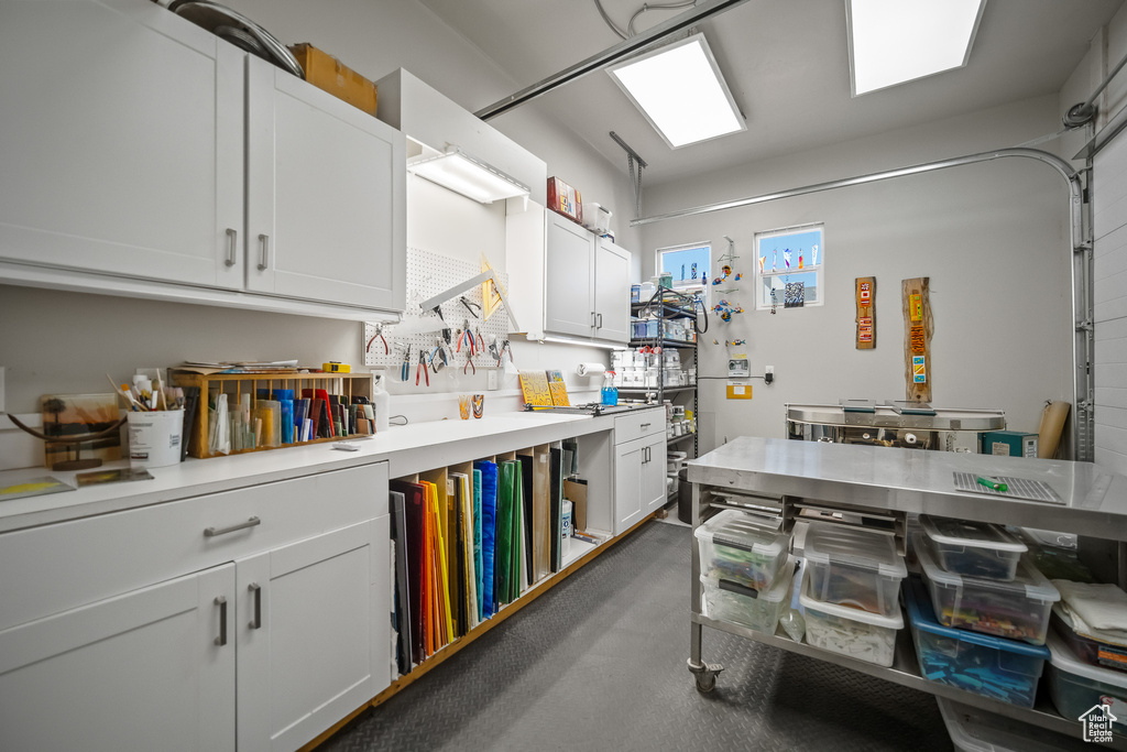 Kitchen with light countertops and white cabinetry