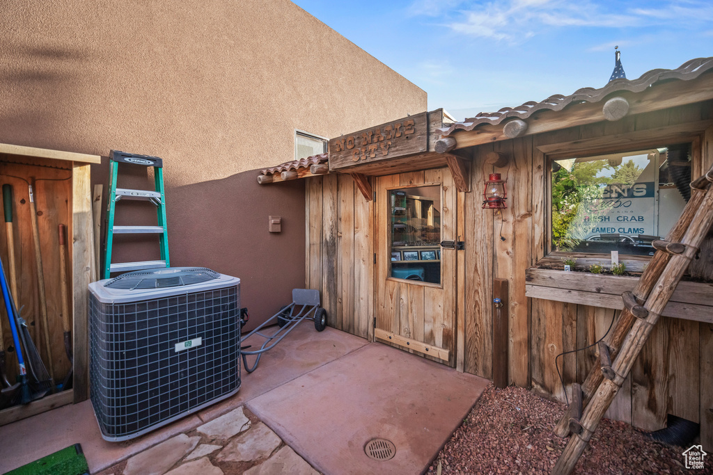 Exterior view of cooling unit and stucco siding