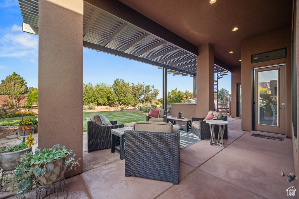 View of patio with outdoor lounge area and a pergola