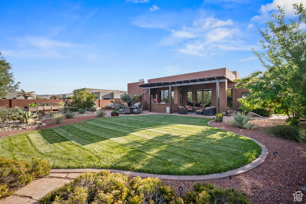 View of green lawn featuring outdoor lounge area and a patio area