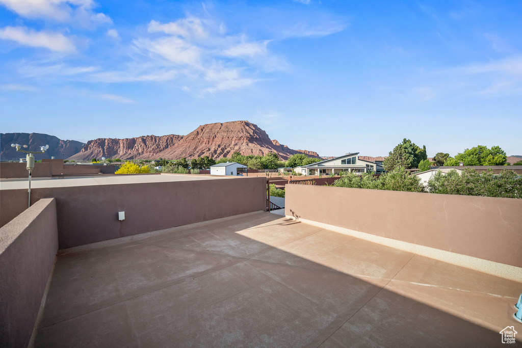 View of patio / terrace with a mountain view and a gate