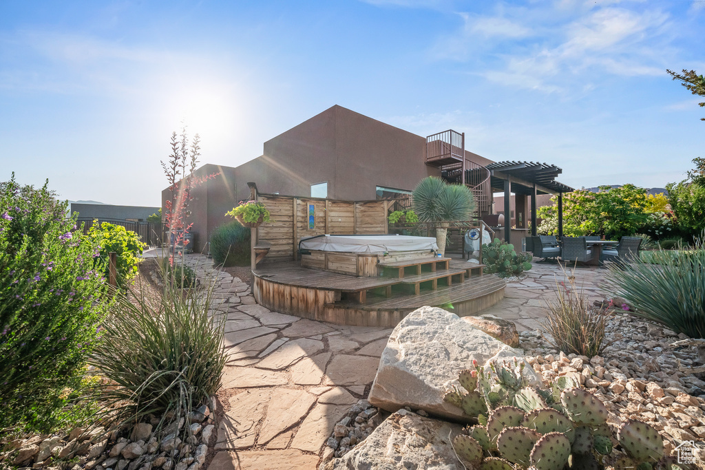 View of patio / terrace with a covered hot tub and a balcony