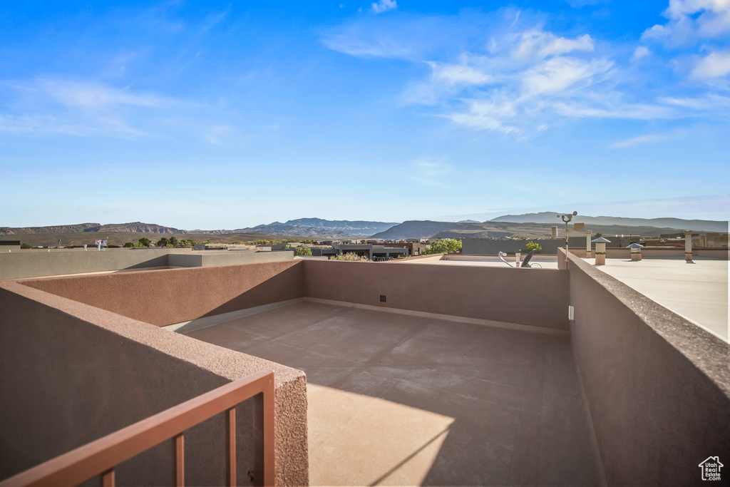 View of patio featuring a mountain view and a balcony