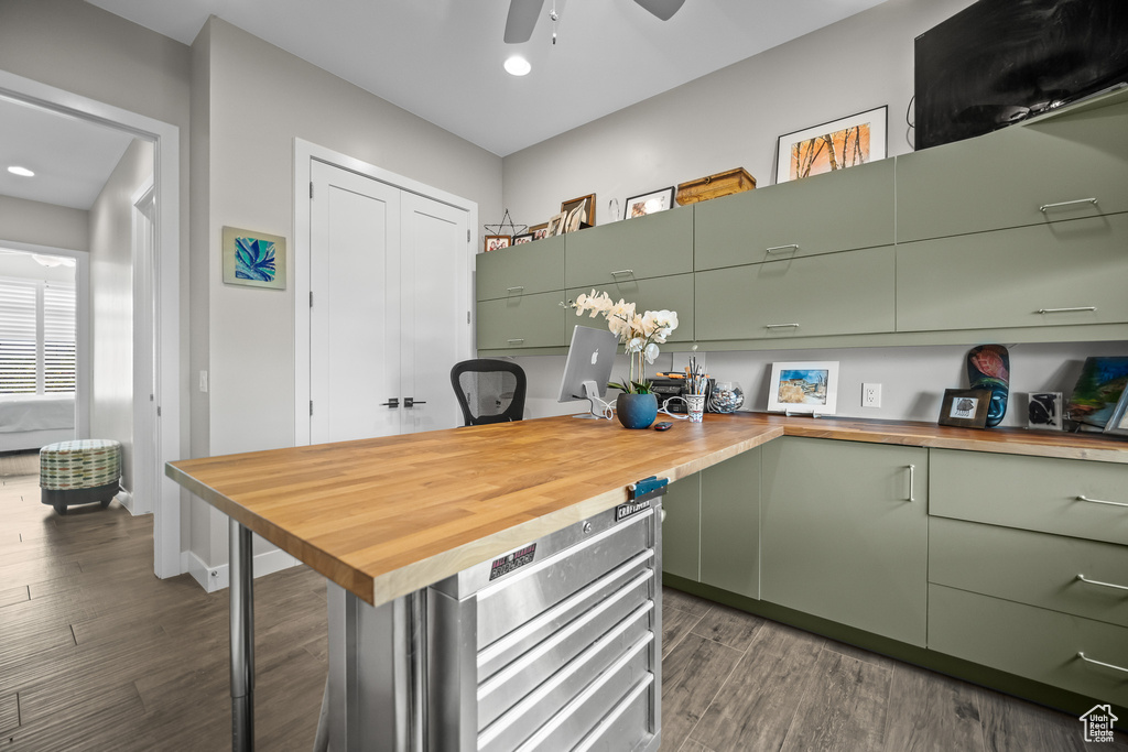 Kitchen featuring wood counters, green cabinets, dark wood finished floors, an office area, and recessed lighting