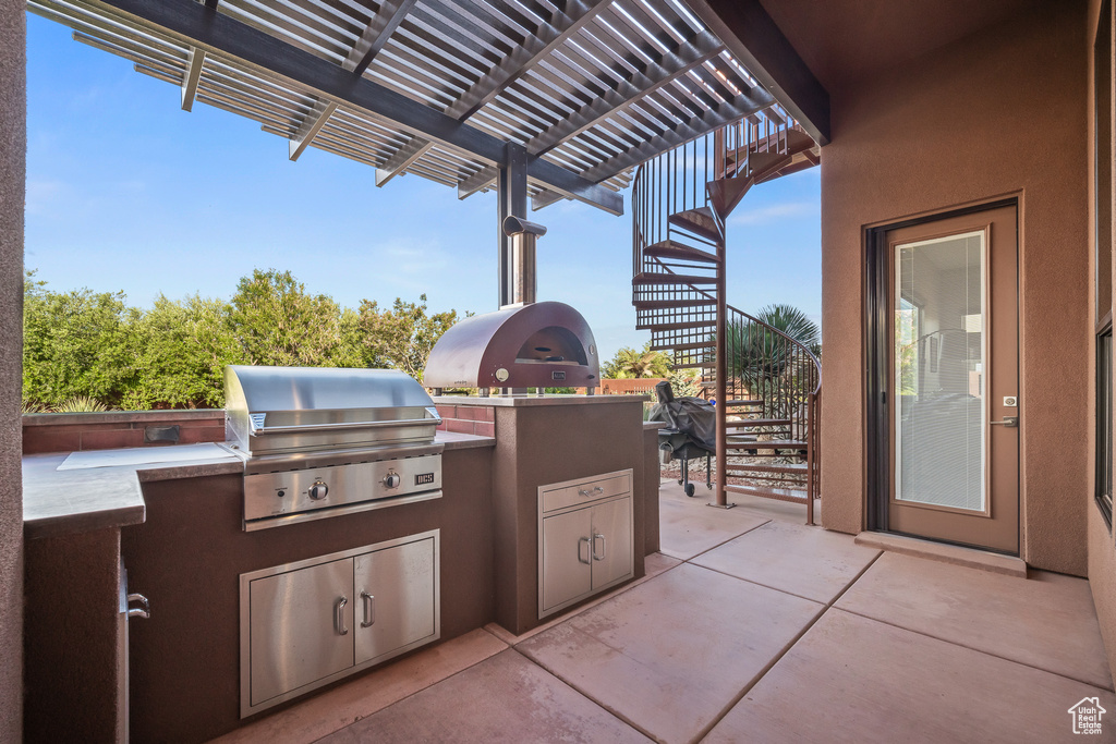 View of patio / terrace with stairway and a pergola