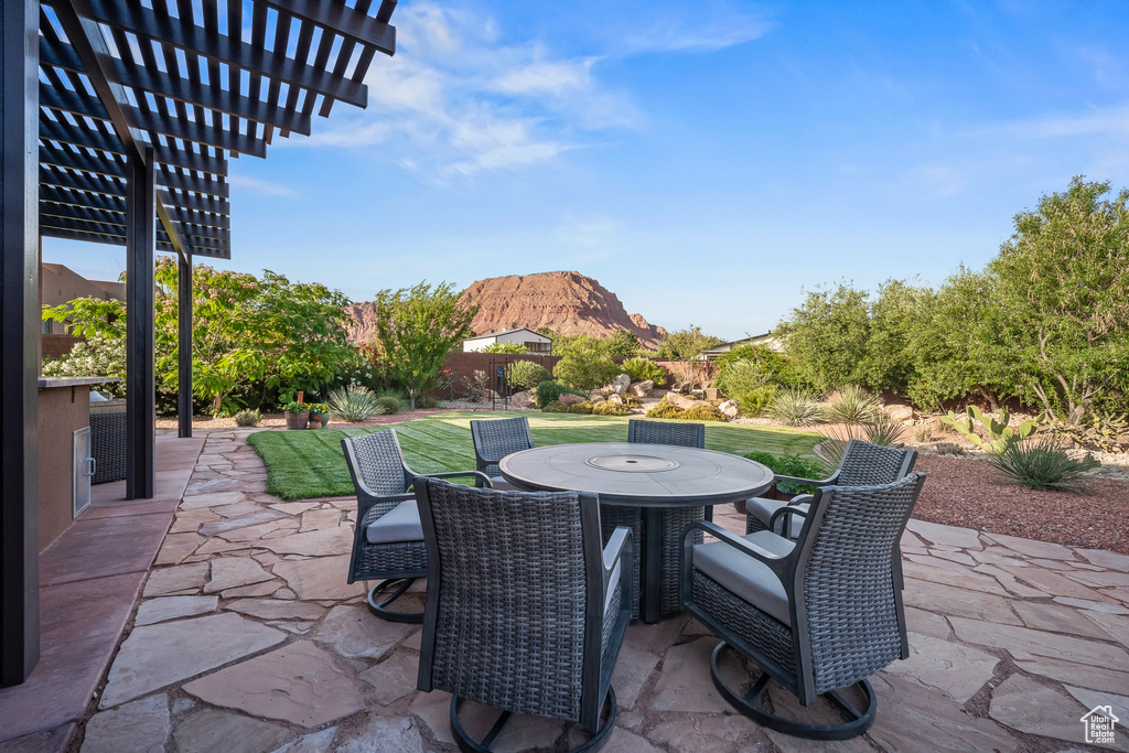 View of patio featuring outdoor dining area and a pergola