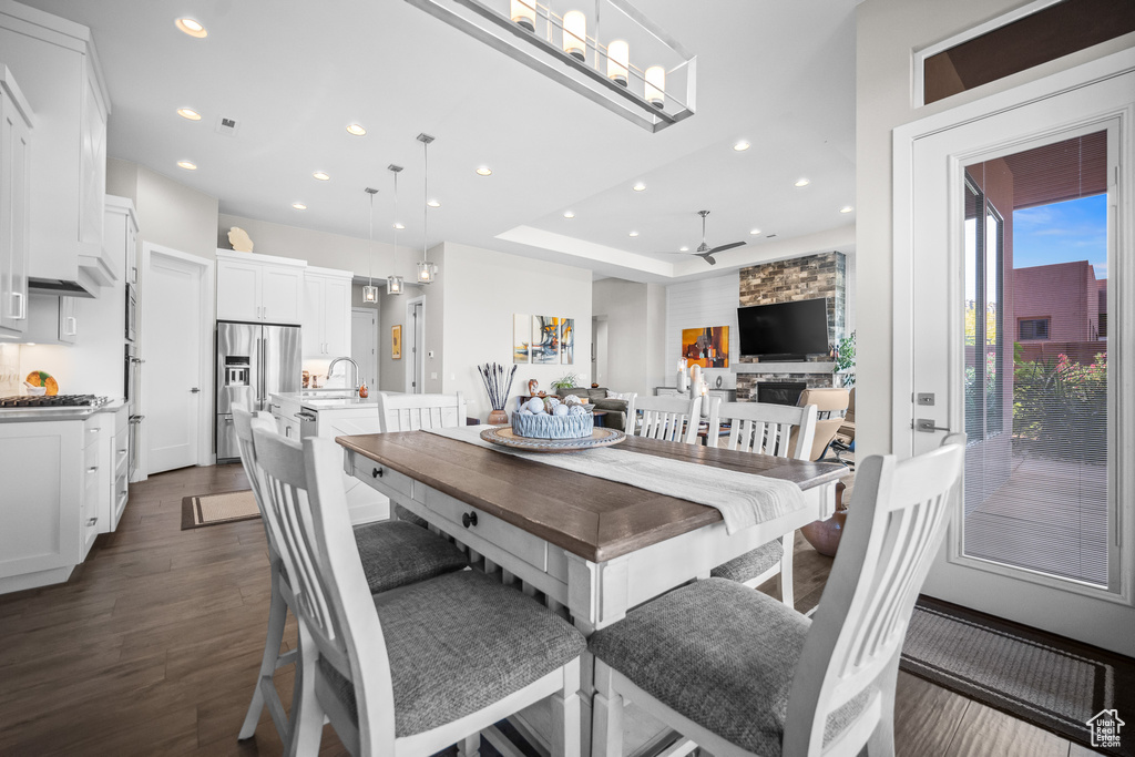 Dining room with dark wood-style flooring, recessed lighting, and ceiling fan