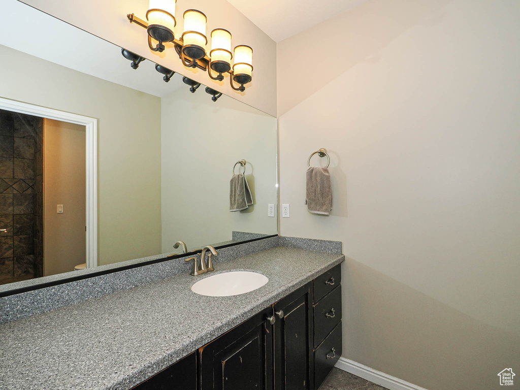 Bathroom featuring vanity, baseboards, and toilet