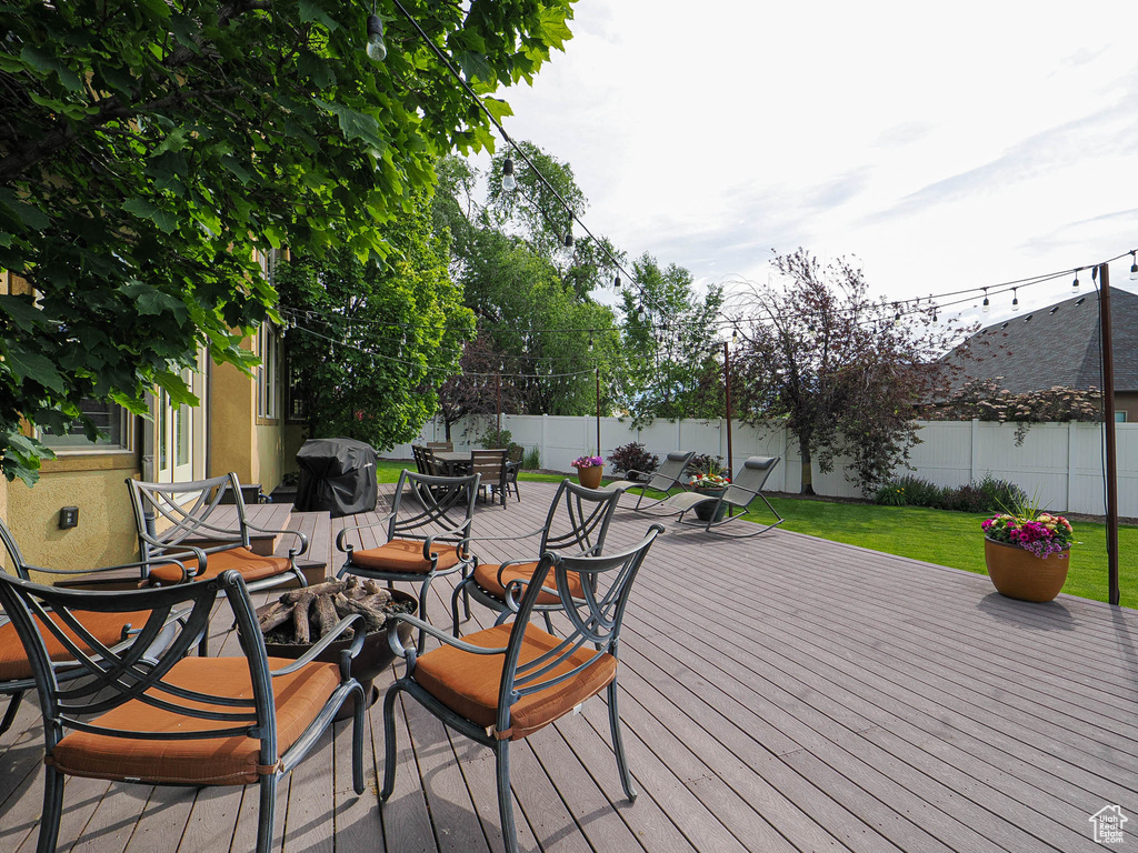 Deck featuring outdoor dining area and a grill